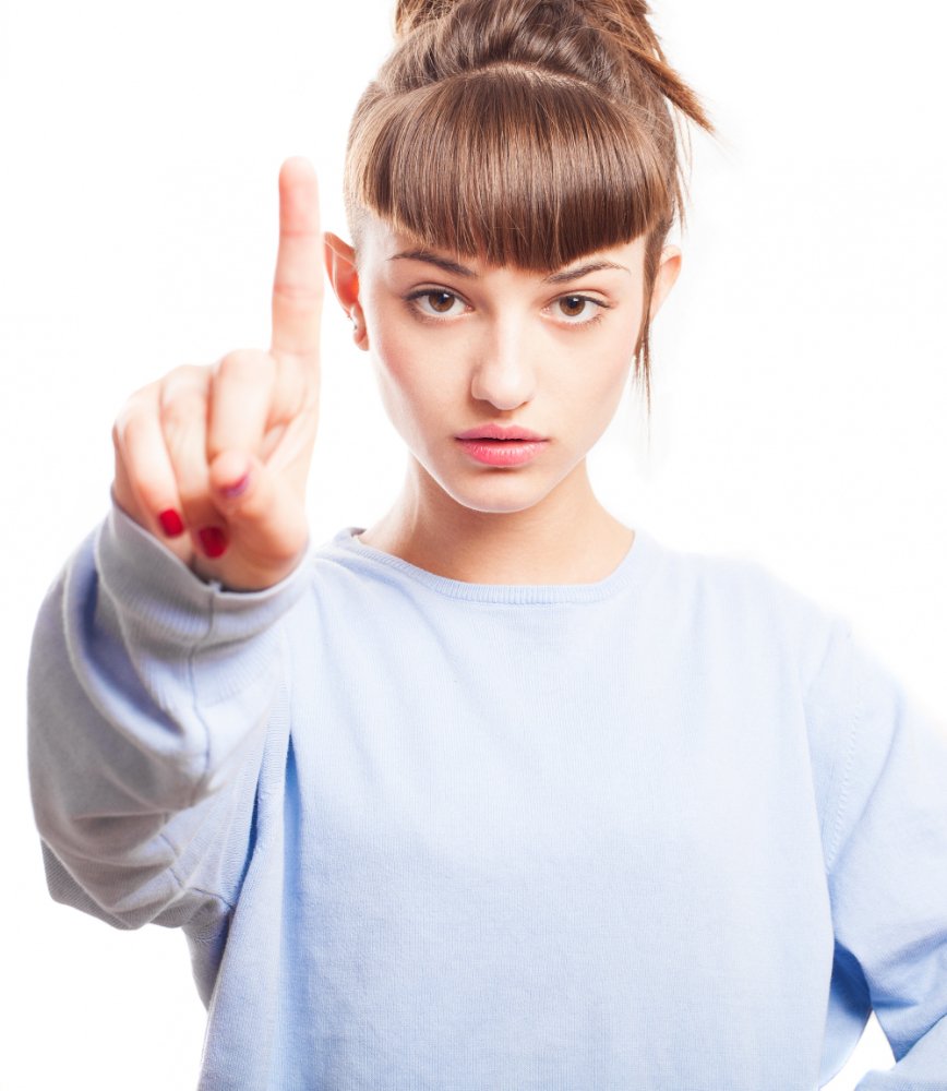 Hübsche junge Dame mit erhobenem Zeigefinger Hübsche junge Dame mit erhobenem Zeigefinger